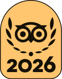Stylized owl face with laurel, number 2026, on a tan background.